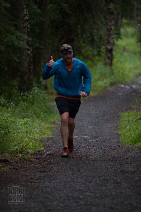 Approaching the mile 70 aid station, still smiling. Photo by Andre Horton.