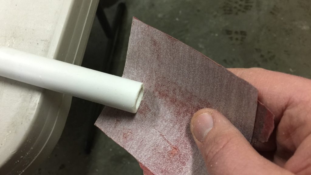 sanding the PVC smooth where I made my cuts